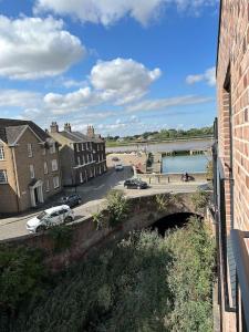 a bridge over a river with buildings and a street at The Penthouse at Purfleet in King's Lynn