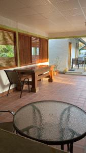 a table and a bench in a room with a patio at Rainforest Yasmin Hotel in Santa Fe