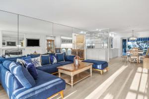 a living room with a blue couch and a table at By The Sea in San Diego