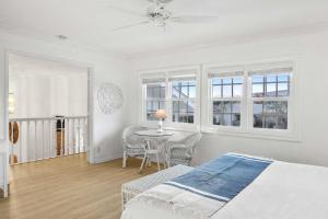 a bedroom with a bed and a table and chairs at By The Sea in San Diego