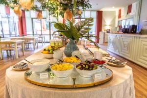 a buffet of fruit on a table in a room at Clube do Lago Hotel in Estoril
