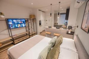 a bedroom with a large bed and a kitchen at Monte 21 - San Giusto in Trieste