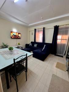 a living room with a couch and a table at Exquisite Modern suite 1bedroom in Busia
