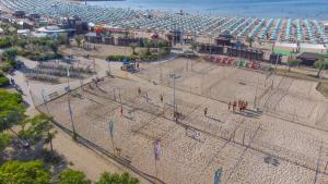 an aerial view of a beach with people playing in nets at Apartment 4 people in Rimini 400m from the beach in Rimini