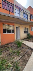 a house with an orange and white at AIRES DEL CERRO 6 CON COCHERA in Salta