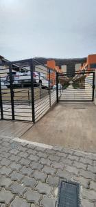 a gate with cars parked in a parking lot at AIRES DEL CERRO 6 CON COCHERA in Salta