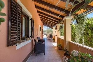 a corridor of a building with chairs and windows at House Ulika in Svetvinčenat