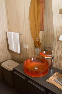 a bathroom with an orange sink on a counter at Stella Maris Case Vacanze in Balestrate