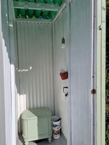 a small shed with a toilet and a door at Glamping in style Bell tent in Ifield