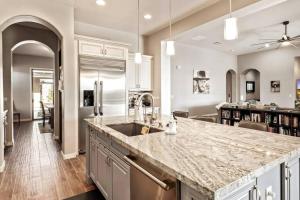 a kitchen with a sink and a counter top at Phoenix Home with heated pool, desert views & hot tub in Anthem