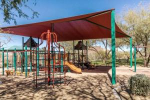 a playground with a slide in a park at Phoenix Home with heated pool, desert views & hot tub in Anthem