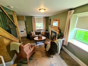 a living room with a couch and a table at Ingleside Cottage in Glaisdale