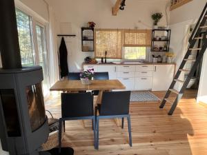 a kitchen with a table and chairs and a stove at Namelis Strazdas in Molėtai