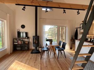 a living room with a table and chairs and a dining room at Namelis Strazdas in Molėtai