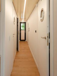 a hallway with white walls and wooden floors at Dom na wodzie LaMare Modern 14 in Bydgoszcz