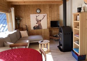 a living room with a couch and a stove at Charmant petit chalet individuel in Briançon