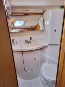 a bathroom with a sink and a toilet in an rv at Lunablu Boat&Sail in Palermo