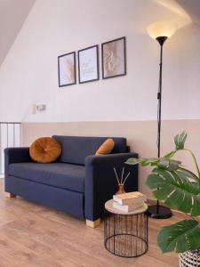 a living room with a blue couch and a table at Ferienpark am Darß - Apartmenthaus 3 in Fuhlendorf