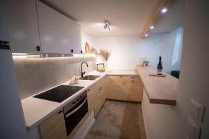 a small kitchen with a sink and a stove at Loft Studios in Artemida