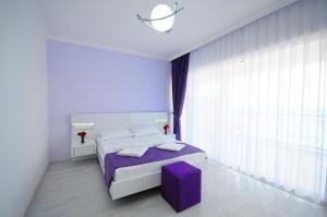 A bed or beds in a room at Fuda Hotel