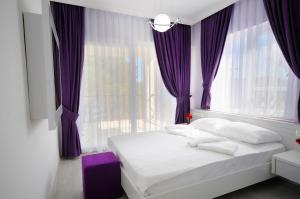 A bed or beds in a room at Fuda Hotel