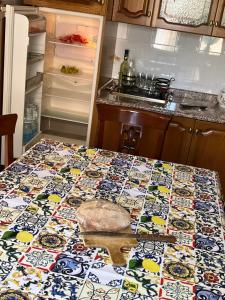 a kitchen with a table with a patterned table cloth at The breath from The soul in Forza dʼAgro