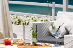 a table with a tray of food and drinks on a patio at Hotel da Cesare Maluentu in Putzu Idu