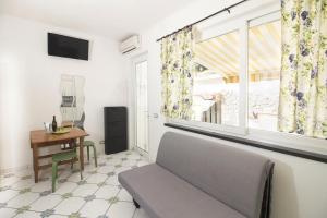 a living room with a couch and a window at La Turrita Apartments in Forio d'Ischia