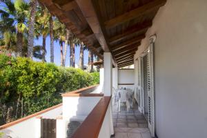 a balcony of a house with palm trees at La Turrita Apartments in Ischia