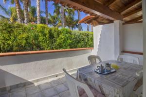 a patio with a table and chairs and a window at La Turrita Apartments in Forio d'Ischia