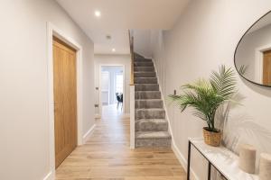 a hallway with a staircase in a house at Green Park House, Private Garage and Parking in Coventry