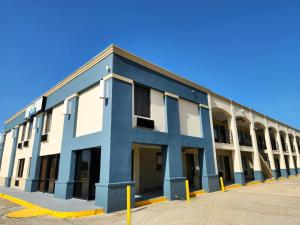 a blue and white building in a parking lot at Days Inn by Wyndham Slidell in Slidell
