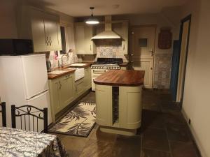 a kitchen with a white refrigerator and a stove at 3 bedroom village house 