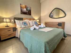 a bedroom with a large bed with a mirror at Skiathos home in Skiathos