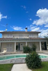 a house with a swimming pool in front of it at Villa Concetta in Torre del Lago Puccini