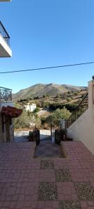 a stairway leading up to a building with mountains in the background at Boutique Eptalofos 15min from airoport and sea in Kouvarás