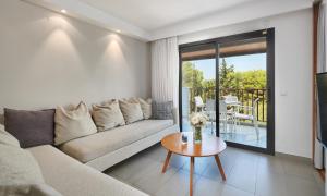 a living room with a couch and a table at Hipotels Cala Bona Club in Cala Bona