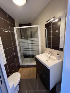Chaleureux Logement - 4 Couchages في Uvernet: حمام مع حوض ومرحاض ومرآة