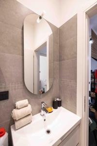 a bathroom with a sink and a mirror at Apartment Design 5 Stelle in Novara