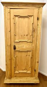 a wooden cabinet with a wooden door in a room at Streiter Rooms in Bolzano