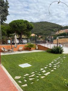 a grassy yard with a sign that says exit at La casa del Gallo in Pietra Ligure