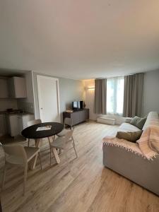 a living room with a couch and a table at La casa del Gallo in Pietra Ligure