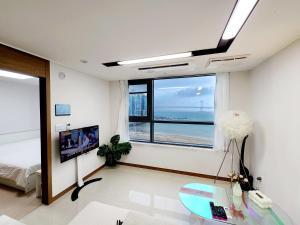 a living room with a view of the ocean at Hot place in Busan