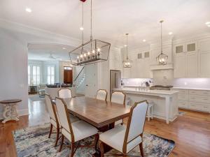 a kitchen and dining room with a wooden table and chairs at Walk to Forsyth in Savannah