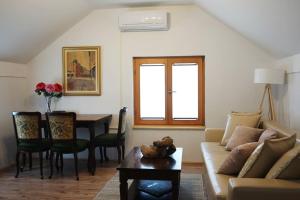 a living room with a couch and a table at Airport Studio Loft - Galleria in Belgrade