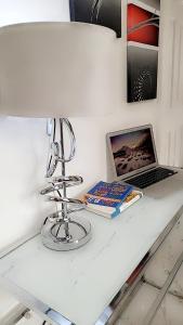 a white counter with a laptop and books on it at Mlandege Town house in Ngambo
