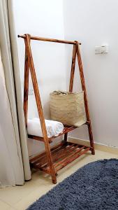 a wooden swing chair in a room with a blue rug at Mlandege apartment in Ngambo