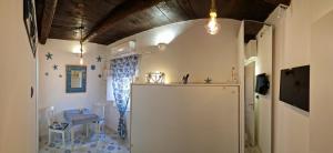 a room with a refrigerator and a table in it at La casa nella Torretta in Formia