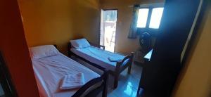 מיטה או מיטות בחדר ב-ROSÁRIO TEMPORADA Hostel