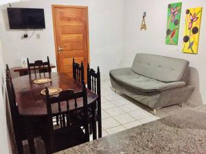 a living room with a table and a couch at Casa Brisas in Luis Correia